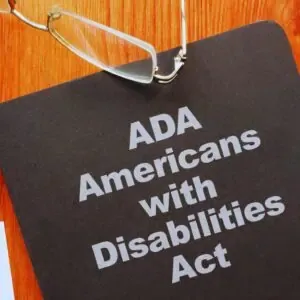 DA Americans with Disabilities Act document with reading glasses, symbolising California small business accessibility compliance