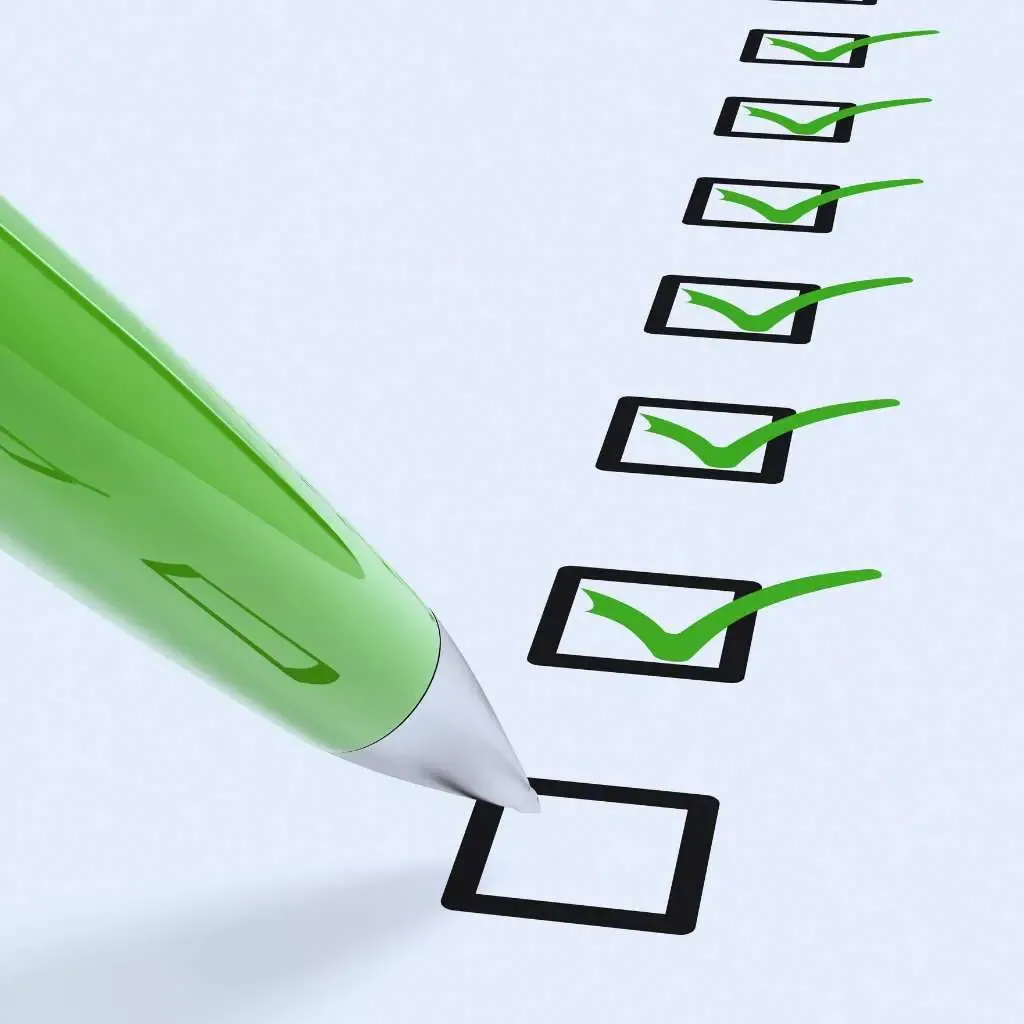 Green pen checking boxes on a digital accessibility compliance checklist