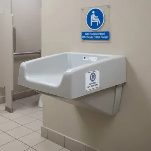 A wall-mounted baby changing station labeled 